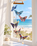 Patience handmade butterfly mobile in a sunlit coastal window